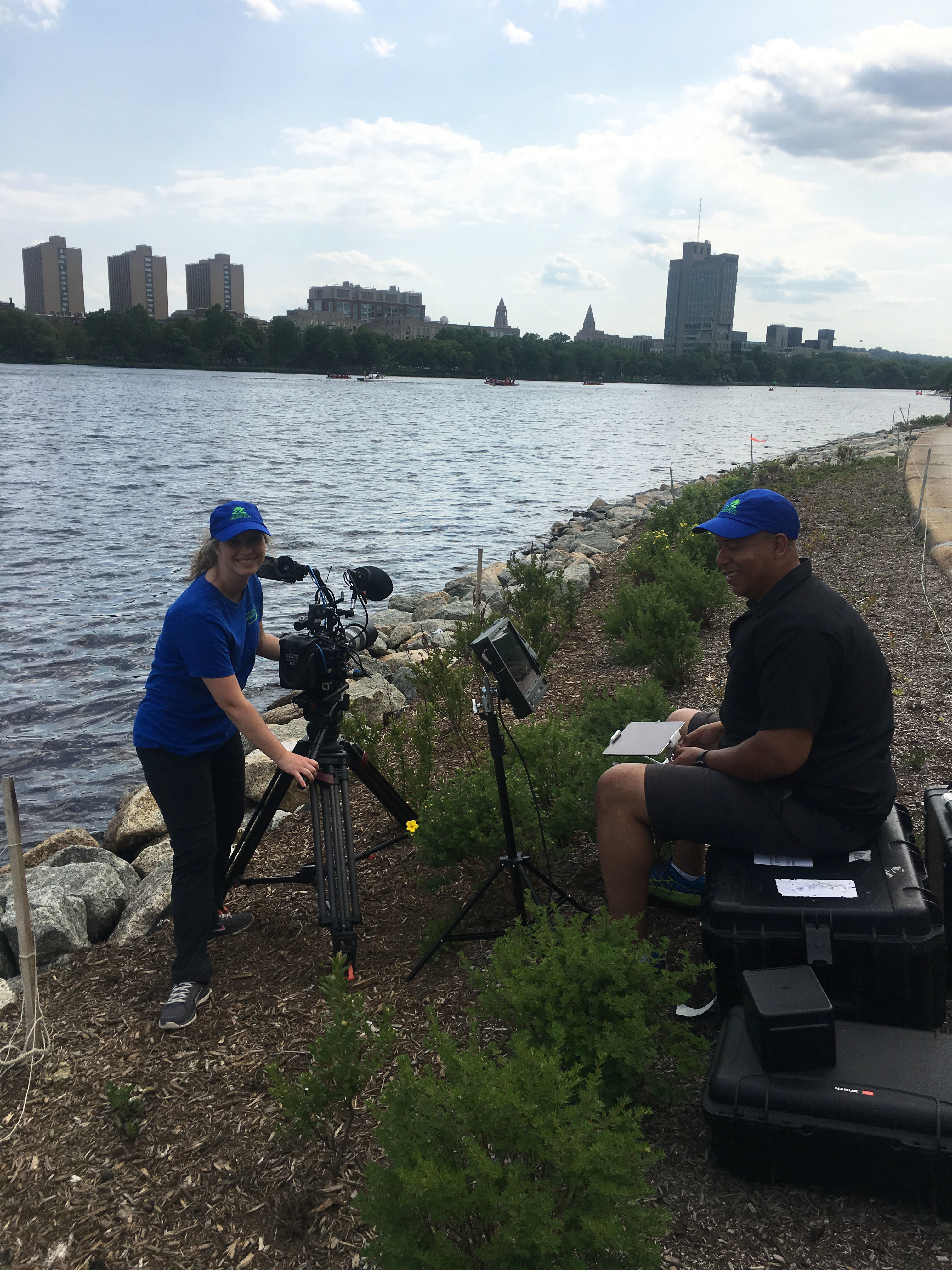 Filmmaker Katie Prentiss Onsager and Cinematographer Corey Lillard set up equipment on the bank of the Charles River.